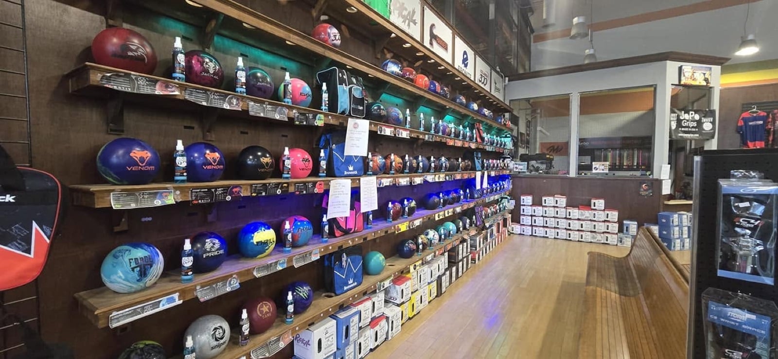 Wall of bowling balls and gear at the Bowling IQ pro shop in Sterling Heights