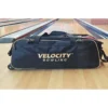 Velocity 3 Ball Triple Tote Black Gold bowling bag on the approach at a BowlersMart pro shop lane